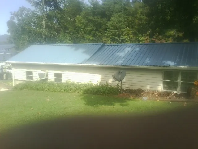 Blue metal roof running the length of a single story home in West Milton